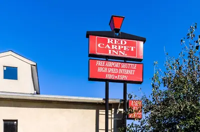 a red carpet inn sign in front of a building at Red Carpet Inn Newark - Irvington NJ in Irvington