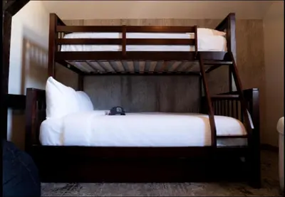 a couple of bunk beds in a room at The Railroad Inn in Cooperstown