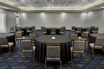 a conference room with tables and chairs in it at Courtyard by Marriott New Haven Orange in Orange