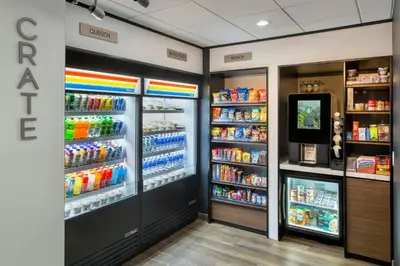 a store aisle with two large refrigerators and drinks at Courtyard by Marriott New Haven Orange in Orange