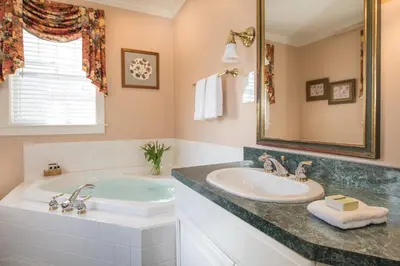 a bathroom with a sink and a large mirror at The INN at Ormsby Hill in Manchester