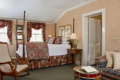 a bedroom with a bed and a chair and a couch at The INN at Ormsby Hill in Manchester