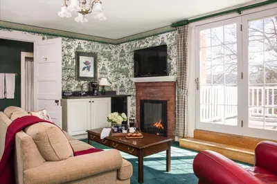 a living room with a couch and a fireplace at The INN at Ormsby Hill in Manchester
