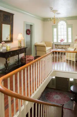 a living room with a staircase and a living room at Daniel Stebbins B and B in South Hadley