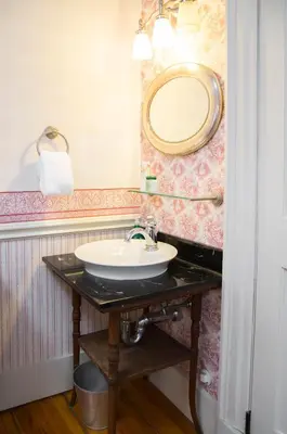 a bathroom with a sink and a mirror at Daniel Stebbins B and B in South Hadley