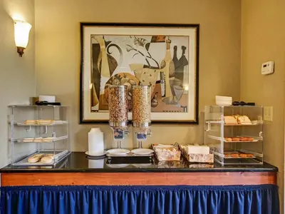 a buffet with plates and food on a table at Red Carpet INN Whippany in Whippany