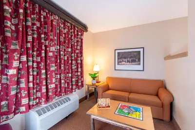 a living room with a couch and a table at Six Flags Great Escape Lodge & Indoor Waterpark in Queensbury