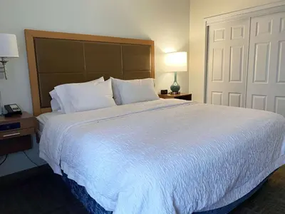 a bedroom with a large bed with white sheets and pillows at Hampton Inn by Hilton Milford in Milford