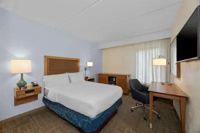 a hotel room with a bed and a desk and a computer at Hampton Inn by Hilton Milford in Milford