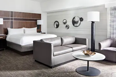 a hotel room with a bed and a couch at New York Marriott Marquis in New York