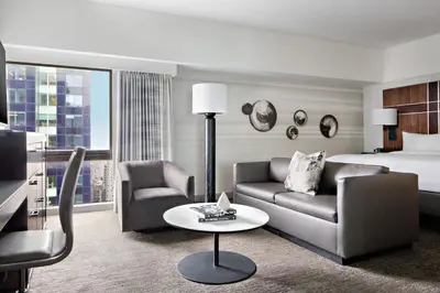 a hotel room with a couch and a bed at New York Marriott Marquis in New York