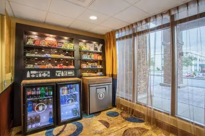 a bar with soda machines in a room with a window at Hampton Inn Fishkill in Fishkill