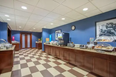 a restaurant with blue walls and a food counter at Hampton Inn Fishkill in Fishkill