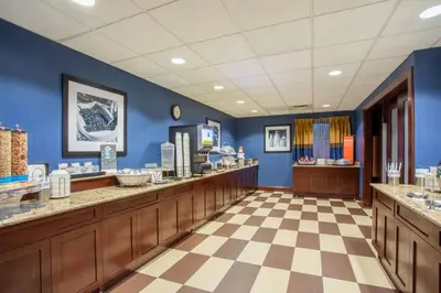 a bathroom with blue walls and a checkered floor at Hampton Inn Fishkill in Fishkill
