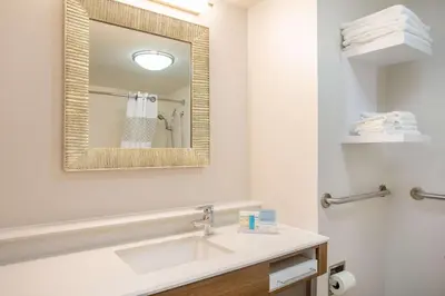 a bathroom with a sink and a mirror at Hampton Inn Fishkill in Fishkill