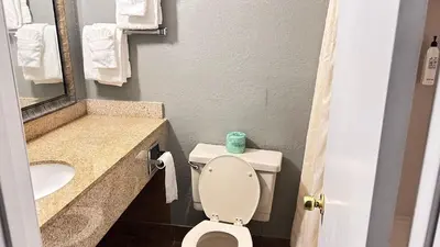 a small bathroom with a toilet and a sink at Latham Inn in Latham