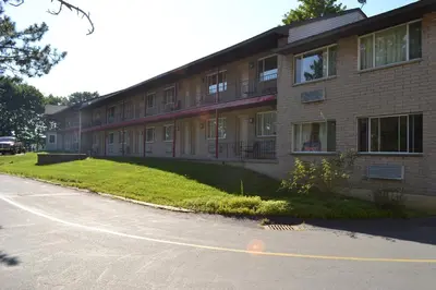 a building with a road in front of it at Latham Inn in Latham