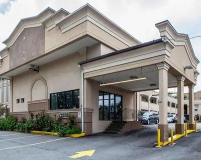 a building with a parking lot in front of it at Rodeway Inn Paterson Great Falls Park Area in Paterson