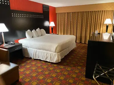 a hotel room with a large bed in a room at Ramada by Wyndham Rochelle Park Near Paramus in Rochelle Park