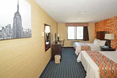 a hotel room with two beds and a window at Corona Hotel New York - LaGuardia Airport in Queens