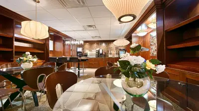 a dining room with a glass table and chairs at Robert Treat Hotel in Newark
