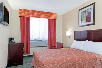 a hotel room with a bed and a window at Super 8 by Wyndham Long Island City LGA Hotel in Queens