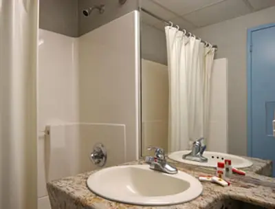 a bathroom with a sink and a shower at Super 8 by Wyndham Long Island City LGA Hotel in Queens