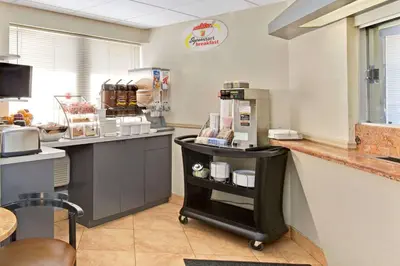 a kitchen with a counter with a coffee maker at Super 8 by Wyndham Long Island City LGA Hotel in Queens