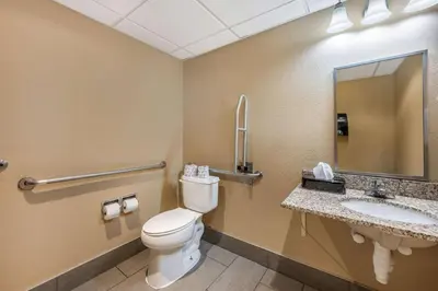 a bathroom with a toilet and a sink and a mirror at Comfort Inn & Suites East Hartford - Hartford in East Hartford