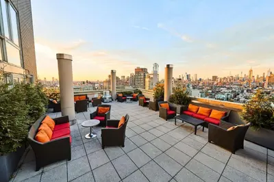 a rooftop patio with furniture and a view of a city at Sheraton Tribeca New York Hotel in New York