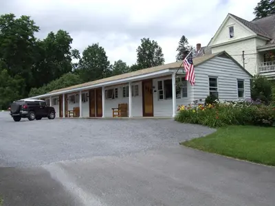 a house with a truck parked in front of it at Mohican Motel in Cooperstown