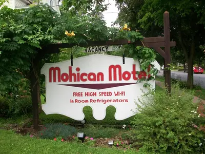 a sign for a museum in a yard at Mohican Motel in Cooperstown