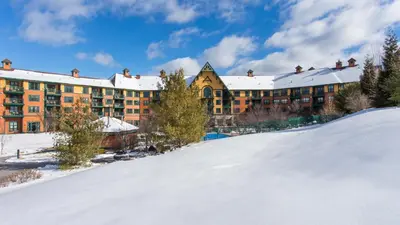 a resort in the snow with a snow covered slope at The Appalachian at Mountain Creek in Vernon