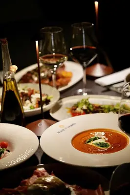 a table with plates of food and glasses of wine at Four Points by Sheraton Manhattan SoHo Village in New York