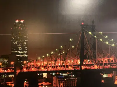 a lit up bridge with a city at night at Red Carpet Inn Elmwood in Elmwood Park