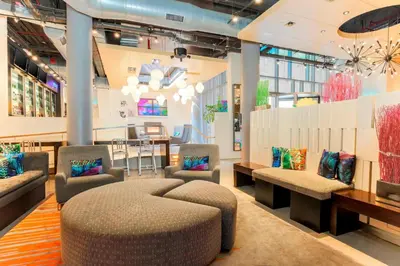 a lobby with couches and chairs and a table at Aloft Harlem in New York