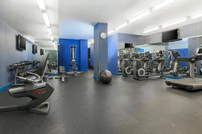 a gym with several treadmills and cardio machines at Aloft Harlem in New York