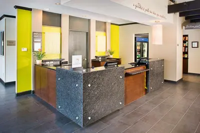a lobby of a hotel with a reception desk at Hilton Garden Inn Albany Airport in Albany