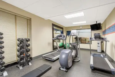 a gym with treadmills and elliptical machines at Hampton Inn & Suites Albany-Airport in Latham