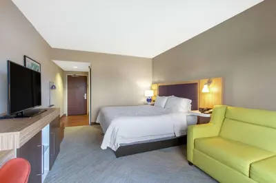 a hotel room with a bed and a television at Hampton Inn & Suites Albany-Airport in Latham