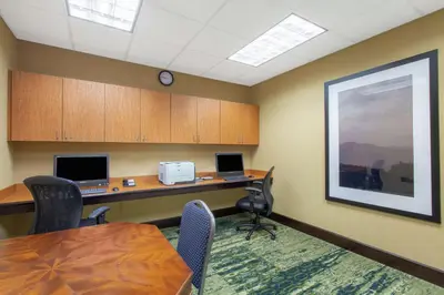 an office with a desk and a table and chairs at Hampton Inn & Suites Albany-Airport in Latham