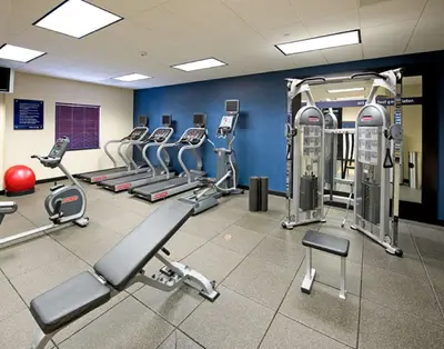 a gym with several treadmills and cardio machines at Hampton Inn Schenectady Downtown in Schenectady