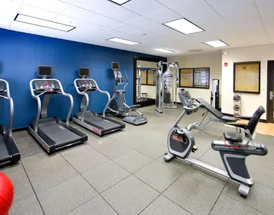 a gym with several treadmills and cardio machines at Hampton Inn Schenectady Downtown in Schenectady