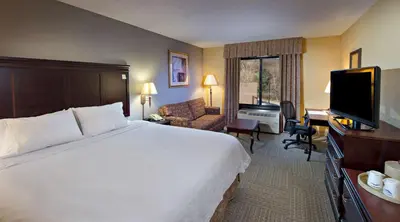 a hotel room with a bed and a flat screen tv at Hampton Inn Bennington in Bennington