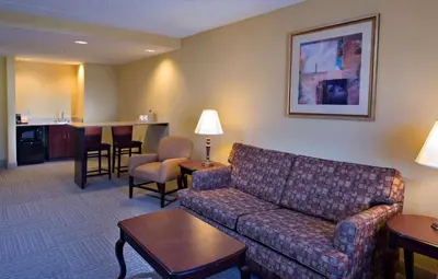 a living room with a couch and a bar at Hampton Inn Bennington in Bennington