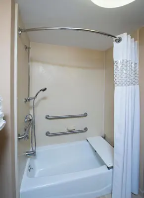 a bathroom with a white tub and a shower curtain at Hampton Inn Bennington in Bennington