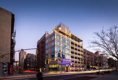 a tall building on a city street at night at The Allen Hotel in New York