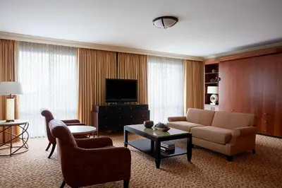 a living room with a couch and a tv at Stamford Marriott Hotel & Spa in Stamford