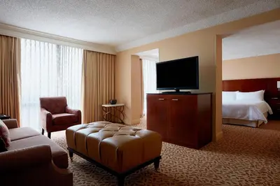 a hotel room with a bed and a flat screen tv at Stamford Marriott Hotel & Spa in Stamford
