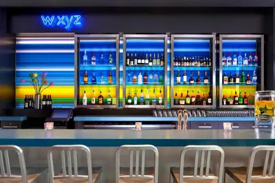 a bar with a lot of bottles of alcohol at Aloft New York Brooklyn in Brooklyn